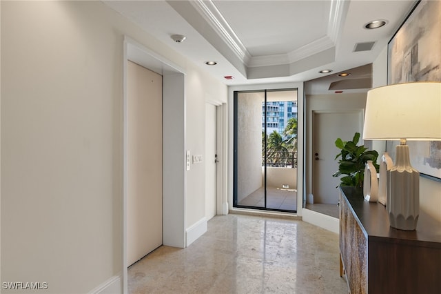 interior space featuring a tray ceiling and ornamental molding