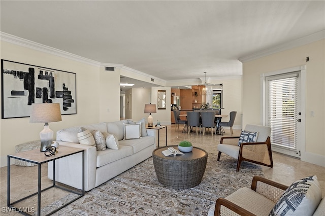 living room featuring a notable chandelier and crown molding