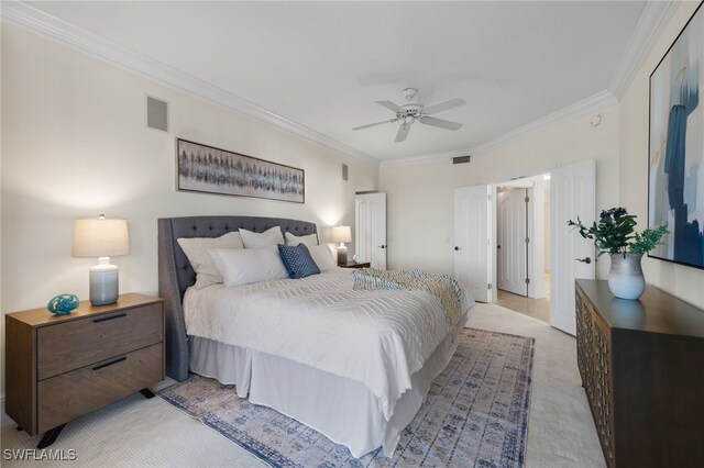 carpeted bedroom with ceiling fan and ornamental molding