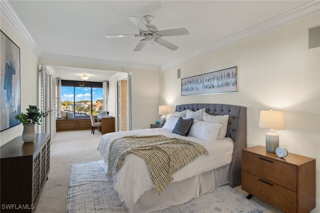 bedroom featuring ceiling fan, light colored carpet, and crown molding