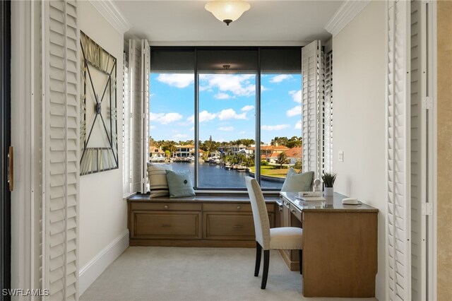 office space with expansive windows, a water view, light colored carpet, and ornamental molding