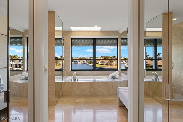 bathroom featuring independent shower and bath, a skylight, a water view, tile patterned floors, and ornamental molding