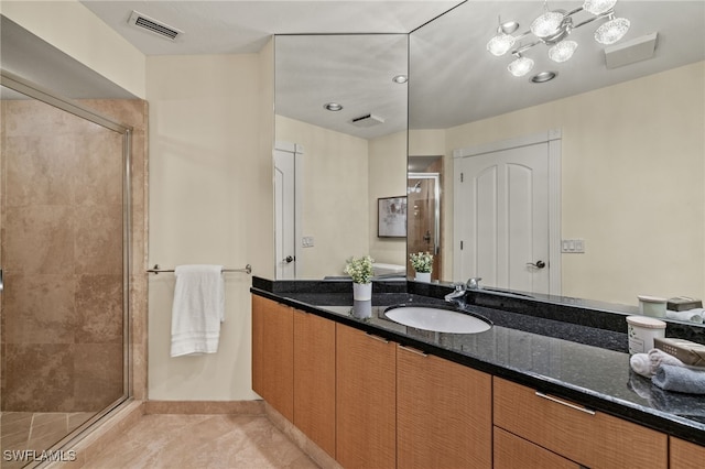 bathroom with vanity, an enclosed shower, and tile patterned flooring