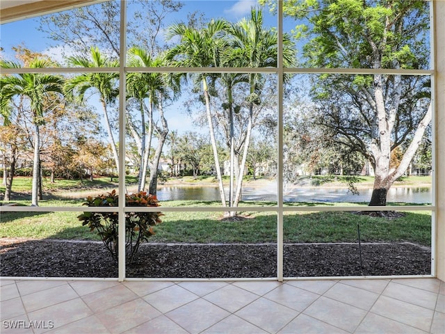 unfurnished sunroom with a water view