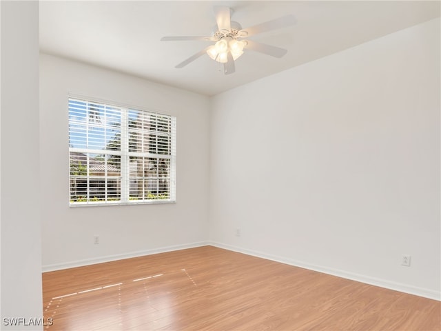 unfurnished room featuring ceiling fan, light hardwood / wood-style flooring, and a healthy amount of sunlight