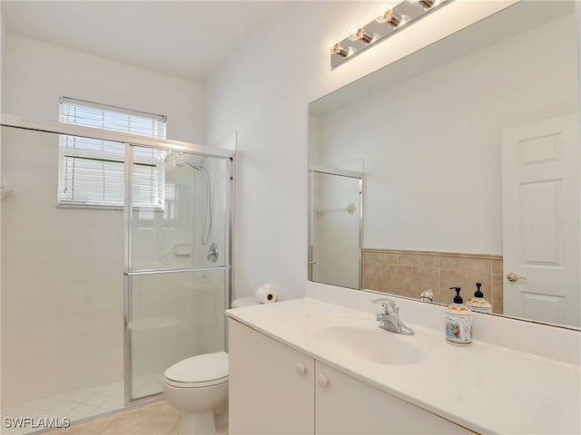 bathroom with tile patterned floors, vanity, toilet, and an enclosed shower