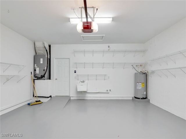 garage featuring sink, heating unit, a garage door opener, and water heater