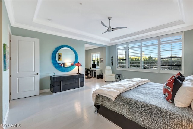 bedroom featuring ceiling fan, light wood-type flooring, ornamental molding, and a tray ceiling