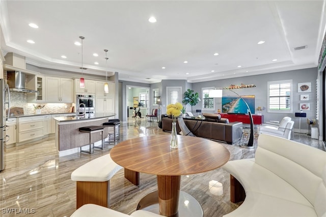 dining area featuring a raised ceiling