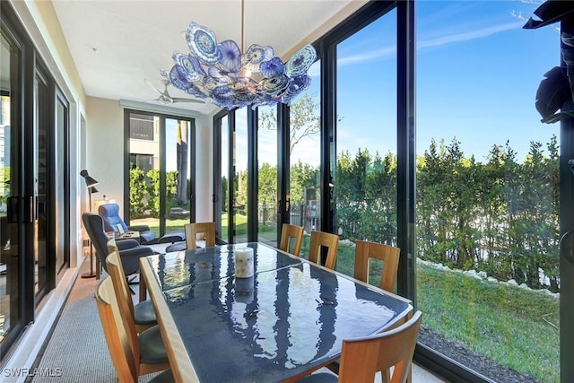 sunroom featuring a notable chandelier