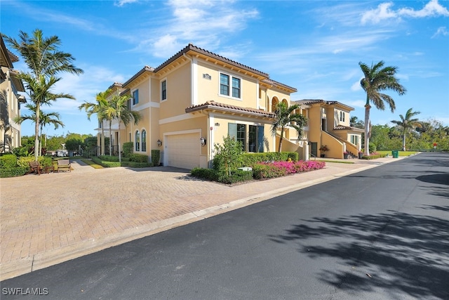 mediterranean / spanish-style home with a garage