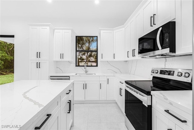 kitchen featuring stainless steel range with electric cooktop, white cabinetry, a healthy amount of sunlight, sink, and light stone counters