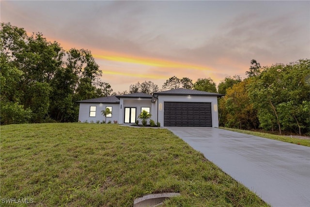 contemporary house featuring a garage and a yard