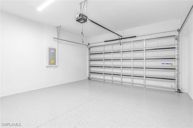 garage with electric panel and a garage door opener