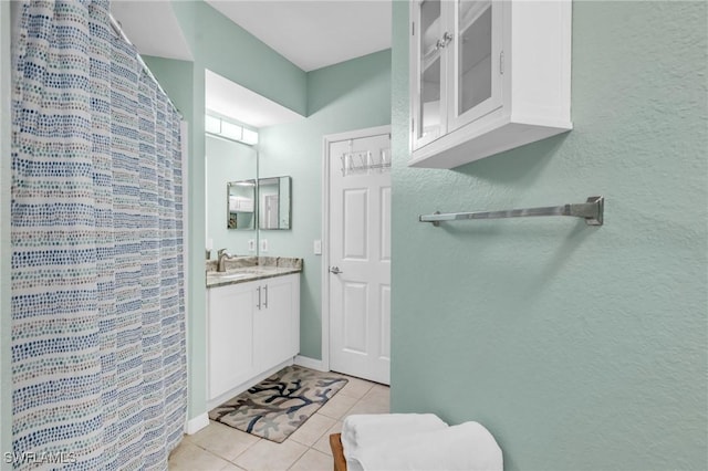 bathroom featuring tile patterned flooring and vanity