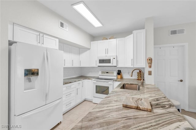 kitchen featuring white cabinetry, sink, light stone counters, backsplash, and white appliances