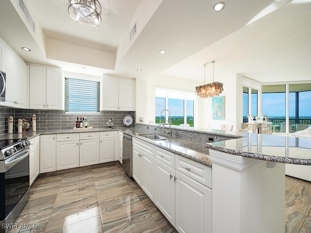 1065 Borghese Ln Unit 701, Naples, FL 34114 - kitchen featuring a sink, appliances with stainless steel finishes, a peninsula, backsplash, and recessed lighting