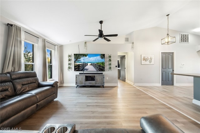 living room with light hardwood / wood-style floors, vaulted ceiling, and ceiling fan