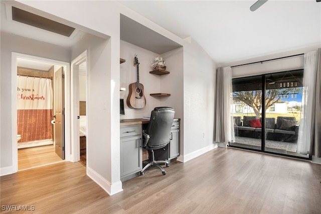 unfurnished office with light wood-type flooring and built in desk