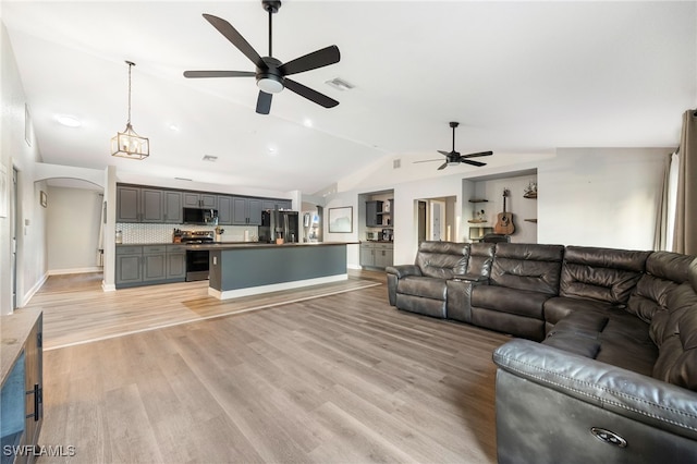 unfurnished living room featuring ceiling fan, light hardwood / wood-style flooring, and lofted ceiling