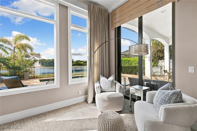 sitting room featuring carpet flooring and baseboards