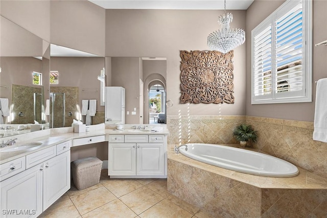 full bathroom with plenty of natural light, a walk in shower, a bath, and vanity