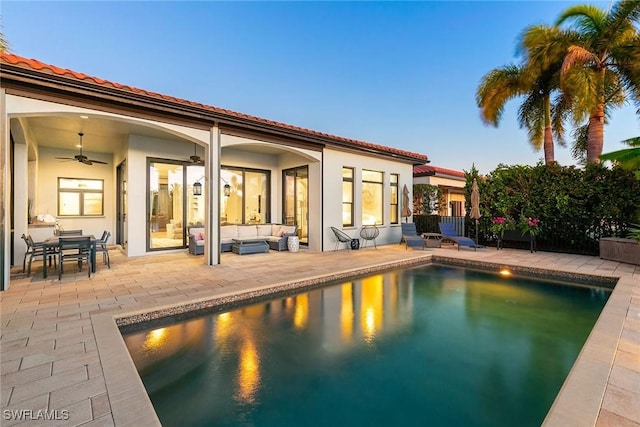 pool featuring a ceiling fan, a patio area, fence, and an outdoor living space