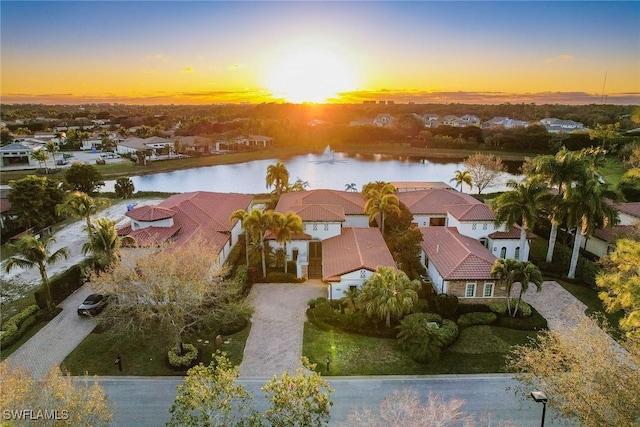 drone / aerial view featuring a water view and a residential view