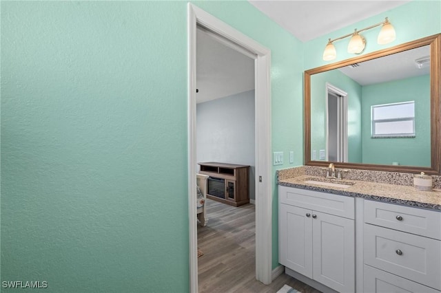 bathroom with hardwood / wood-style floors and vanity