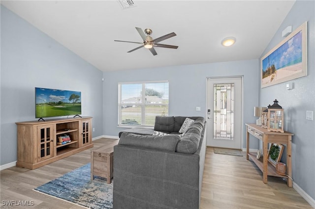 living room with ceiling fan, light hardwood / wood-style flooring, and vaulted ceiling