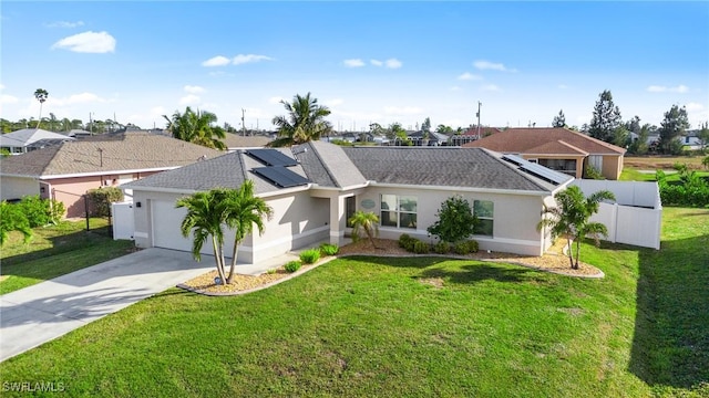 ranch-style home featuring a front lawn, a garage, and solar panels