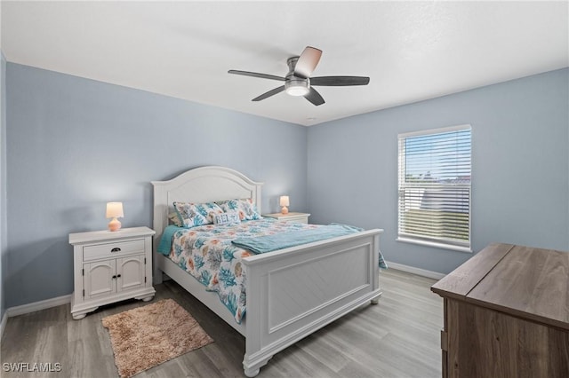 bedroom with wood-type flooring and ceiling fan