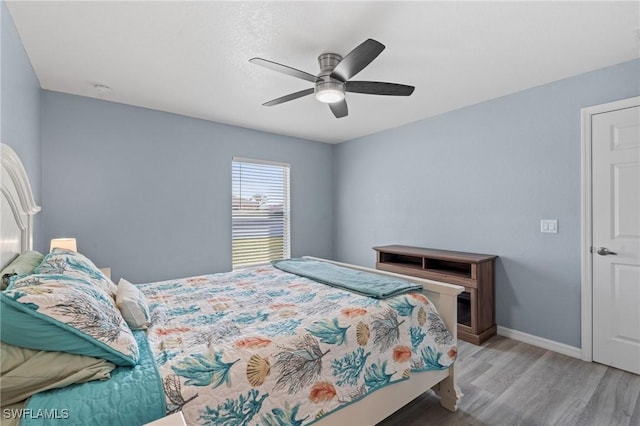 bedroom with light wood-type flooring and ceiling fan