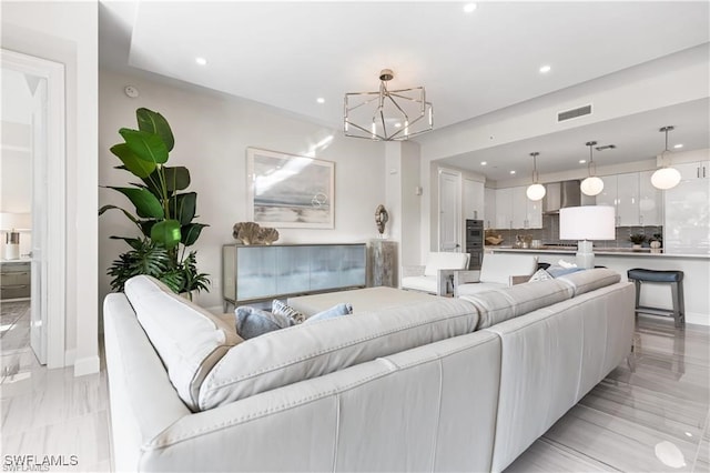 living room featuring a notable chandelier