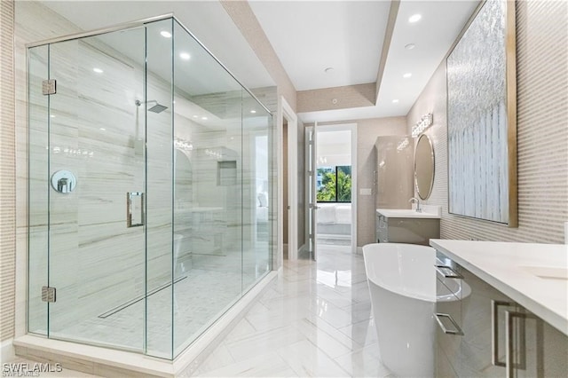 bathroom with shower with separate bathtub and vanity