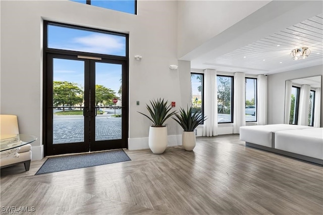 foyer featuring french doors, parquet floors, wooden ceiling, and a notable chandelier