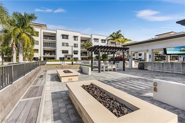 view of home's community featuring a pergola, a patio area, and a fire pit