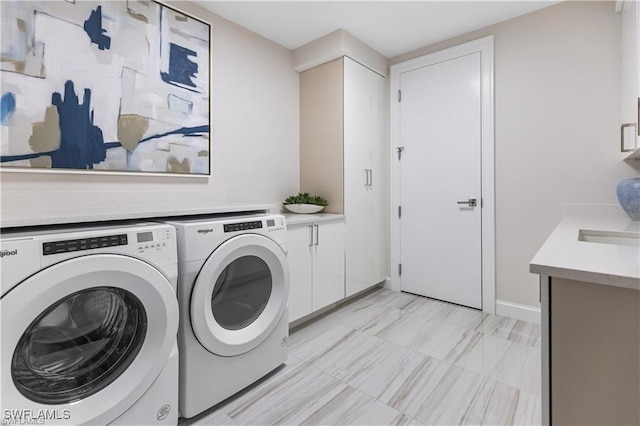 laundry room with cabinets and washer and clothes dryer