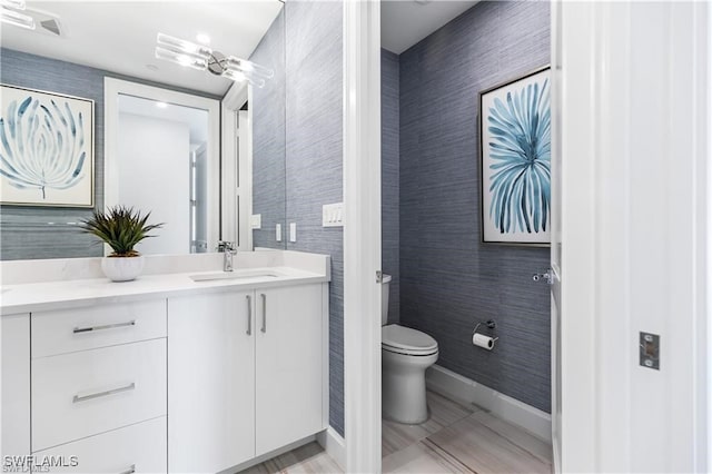 bathroom with tile patterned flooring, vanity, and toilet