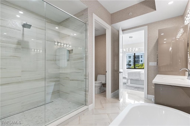 full bathroom featuring shower with separate bathtub, vanity, and toilet