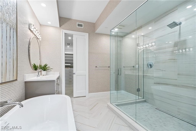 bathroom featuring vanity and plus walk in shower