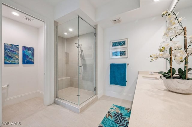 bathroom featuring tile patterned floors, vanity, and a shower with door