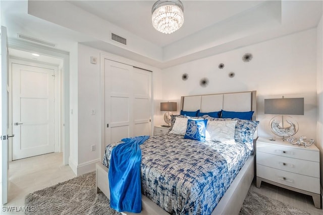 bedroom featuring a chandelier and a closet