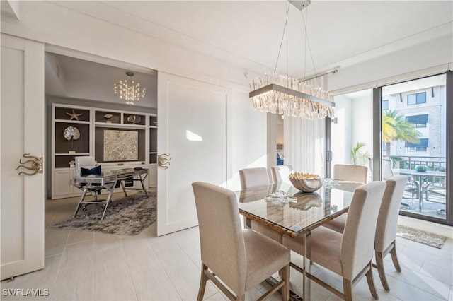 dining area with built in shelves and an inviting chandelier