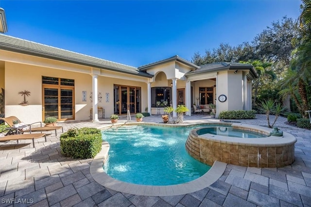 view of pool with an in ground hot tub and a patio area