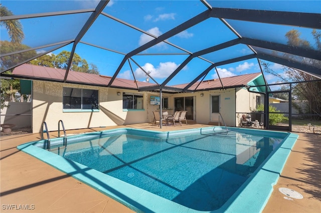 view of pool with a lanai and a patio area