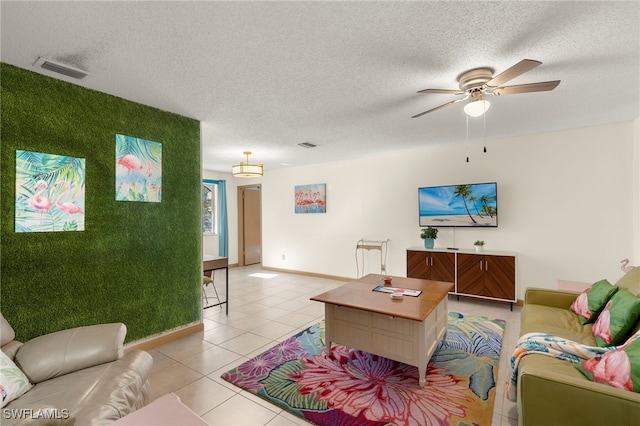 tiled living room with a textured ceiling and ceiling fan