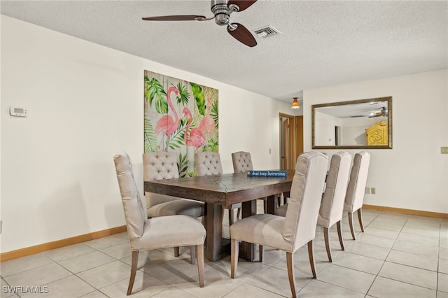 dining space with light tile patterned floors, a textured ceiling, and ceiling fan