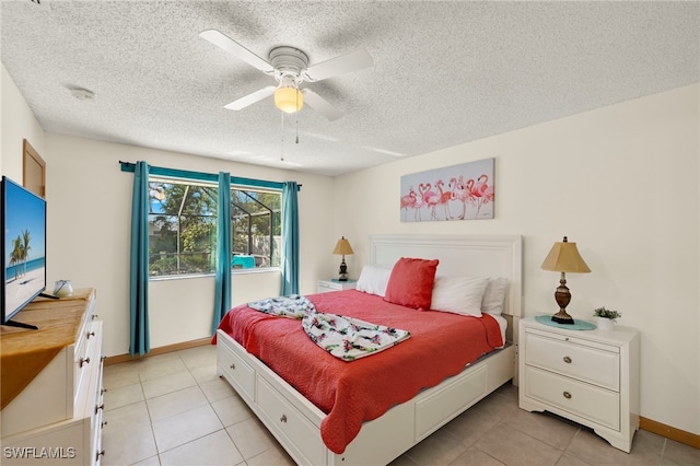 bedroom with a textured ceiling, ceiling fan, and light tile patterned flooring