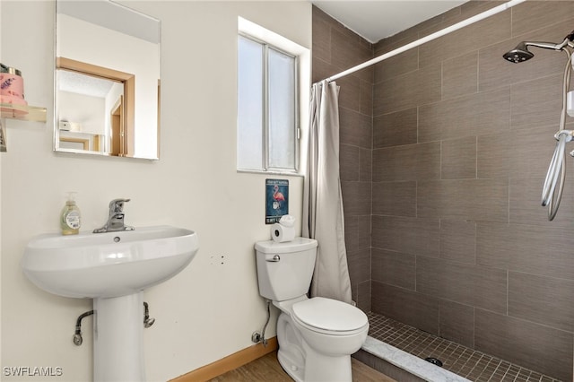 bathroom featuring curtained shower and toilet